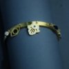 Gold cuff Kada bracelet with evil eye hanging charms by silly owl