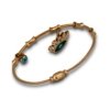 a bamboo look cuff kada bracelet with evil eye hanging chars a magnetic closure and rose gold finish by silly owl