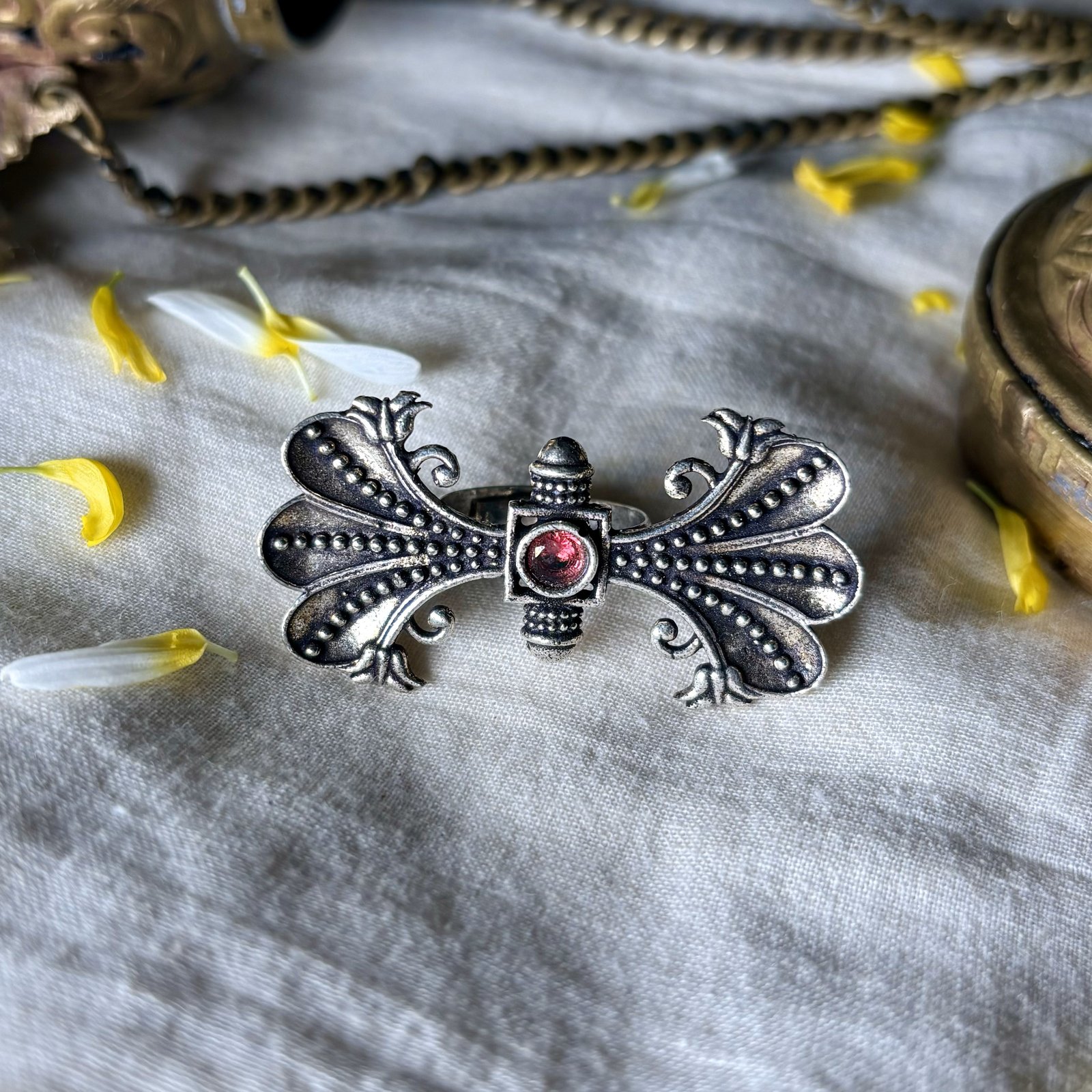 an oxidised finish floral filigree long ring with a red stone by silly owl