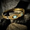 enameled hamsa hand with a star and enameled evil eye in the center gold electroplating finish cuff kada bracelet band by silly owl