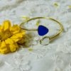 minimal design 2 triangular stone in a royal blue and transparent look colour adjustable fit kada in a gold finish by silly owl