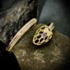 serpant snake cuff bangle with purple setting ad stones by silly owl