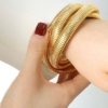 trending spring elasticated triple layer entangled gold statement bracelet by silly owl