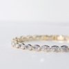 gold finish with ad artificial diamond having an oval shape elegant tennis bracelet anti tarnish water resistant jewelry by silly owl