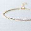 gold finish with ad artificial diamond having round 1.5mm diamonds dainty thin elegant tennis bracelet anti tarnish water resistant jewelry by silly owl