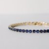 gold finish with ad artificial diamond having round blue diamonds elegant tennis bracelet anti tarnish water resistant jewelry by silly owl