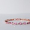 rose gold finish with ad artificial diamond stones of a drop shaped pink and round diamond elegant tennis bracelet anti tarnish water resistant jewelry by silly owl