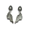 contemporary design oxidised earrings by silly owl with a floral top black stones and pearl and a hanging leaf design