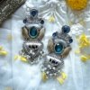 dual tone silver gold polish oxidised earrings with blue zirconia stone and lotus design with pearls statement jewellery by silly owl