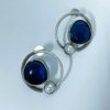 modern contemporary quirky oxidised earring design by silly owl with a blue monalisa stone and pearl in a circular design 1